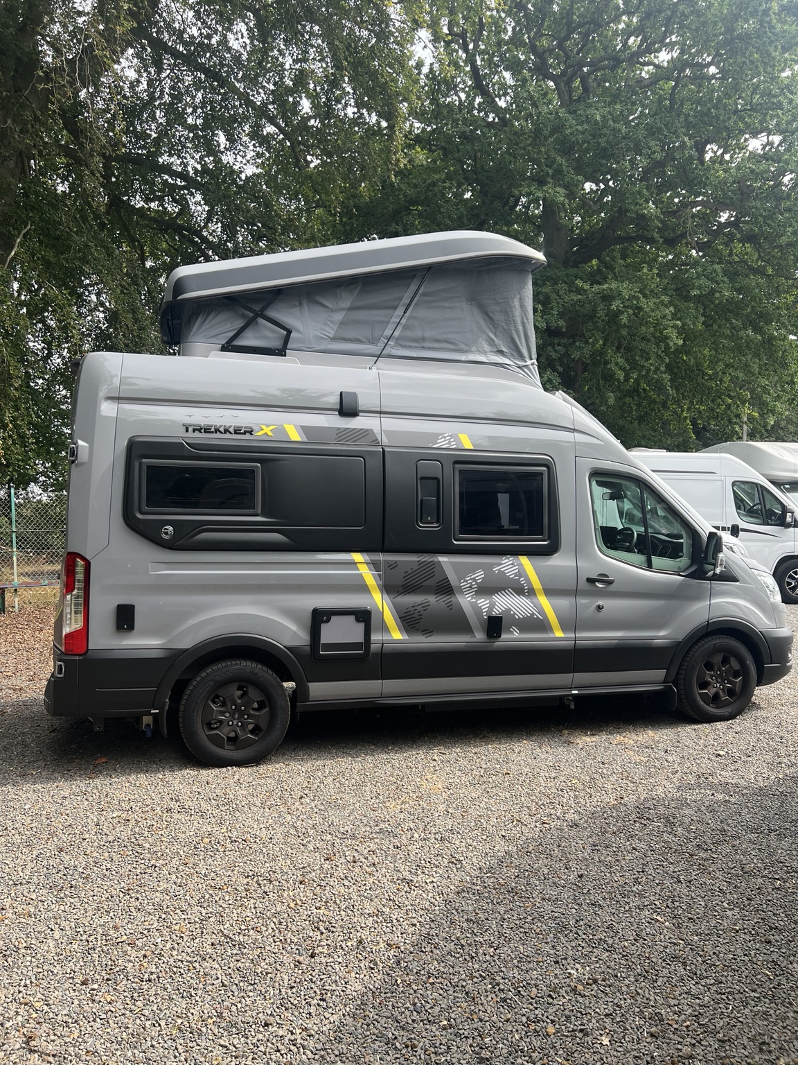 Grey Swift Trekker X campervan with its pop-top roof raised